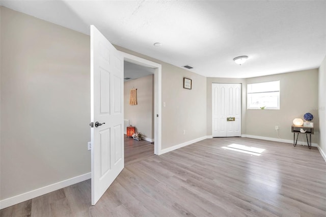 spare room with light wood-type flooring