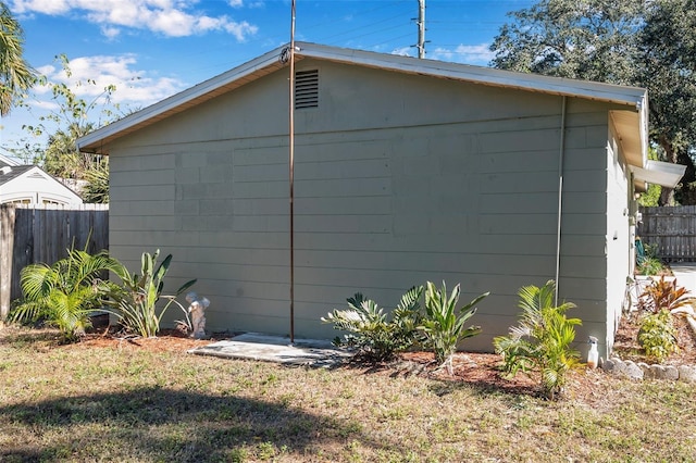 view of side of home featuring a lawn