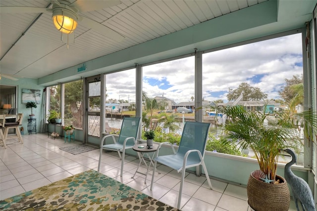 sunroom / solarium featuring a water view