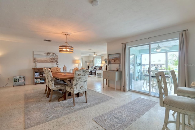 dining space featuring a textured ceiling and an inviting chandelier