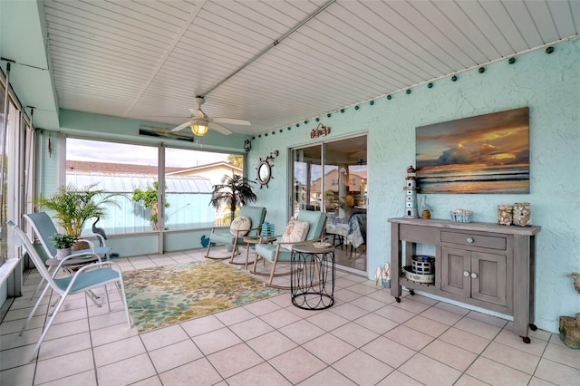 sunroom / solarium featuring ceiling fan and wood ceiling