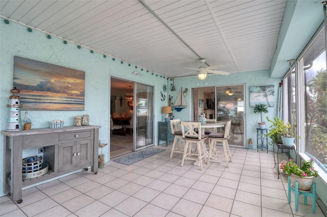 sunroom / solarium with ceiling fan and wooden ceiling