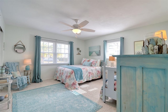 bedroom featuring carpet flooring, ceiling fan, and multiple windows