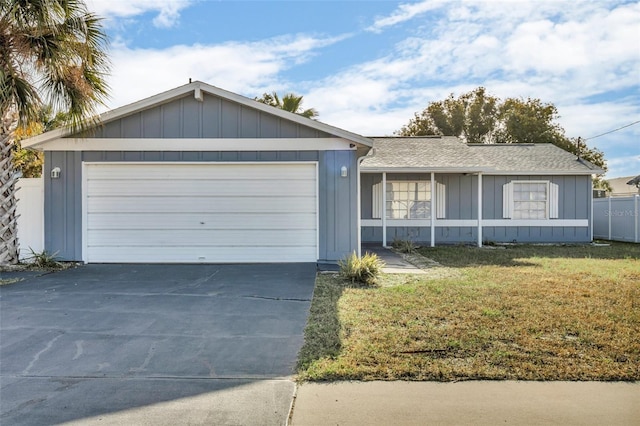 ranch-style house featuring a garage and a front lawn