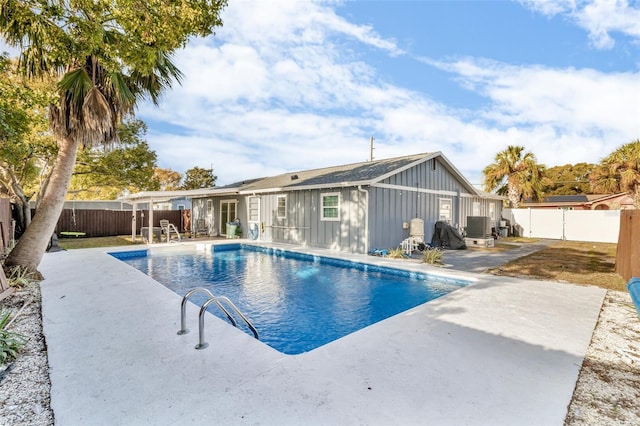 view of pool featuring a patio and central AC unit