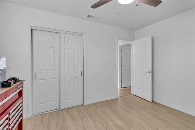 bedroom featuring ceiling fan, a closet, and light hardwood / wood-style floors