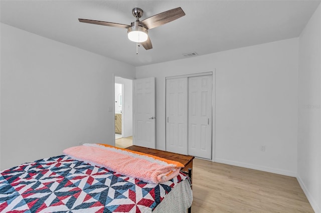 bedroom featuring ceiling fan, light wood-type flooring, and a closet