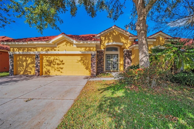 mediterranean / spanish house featuring french doors and a garage