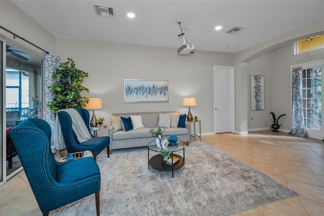 tiled living room with recessed lighting, visible vents, and baseboards