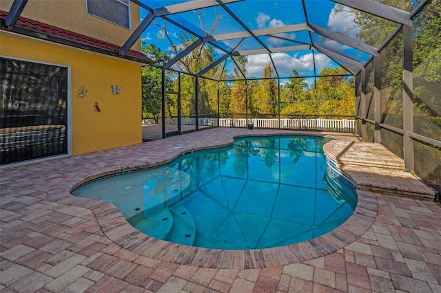 view of pool featuring a fenced in pool, a lanai, and a patio