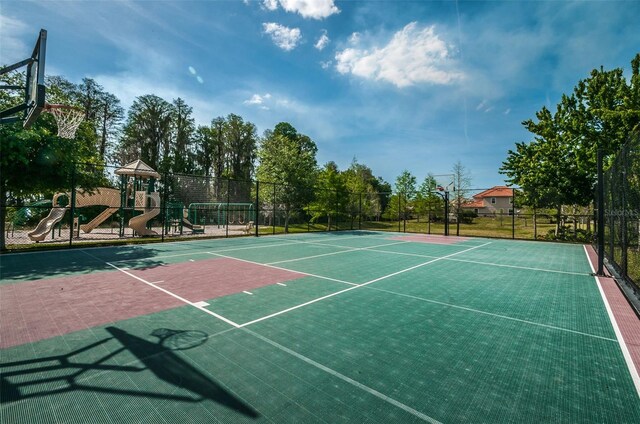 view of basketball court with playground community, fence, and community basketball court