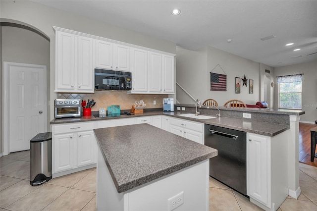11645 Belle Haven Dr, New Port Richey, FL 34654 - kitchen featuring black appliances, a sink, a peninsula, white cabinetry, and tasteful backsplash
