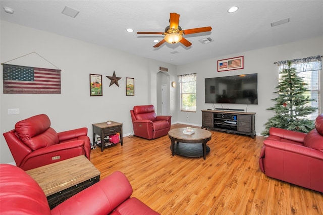 11645 Belle Haven Dr, New Port Richey, FL 34654 - living area featuring light wood-style floors, arched walkways, recessed lighting, ceiling fan, and baseboards