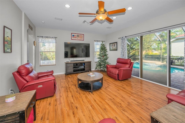 11645 Belle Haven Dr, New Port Richey, FL 34654 - living room featuring healthy amount of natural light, wood finished floors, ceiling fan, recessed lighting, and baseboards