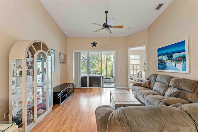 living room featuring light wood-type flooring and ceiling fan