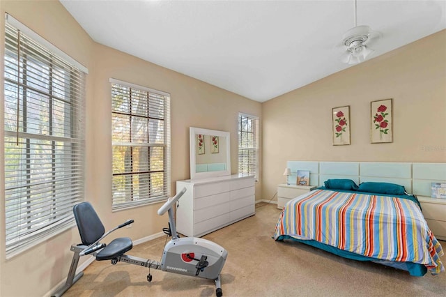 bedroom with light colored carpet and vaulted ceiling