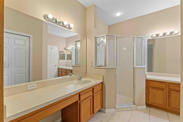 bathroom with tile patterned flooring, vanity, and an enclosed shower