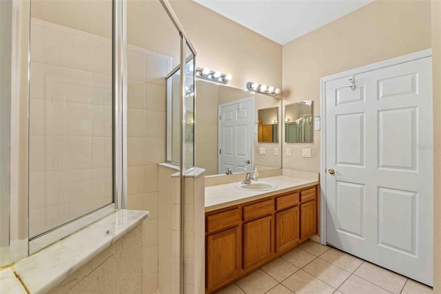 bathroom featuring tile patterned floors, vanity, and an enclosed shower