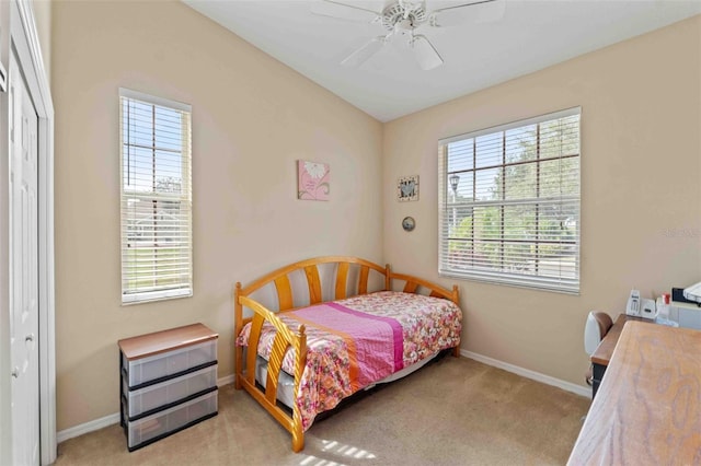 bedroom with ceiling fan, a closet, and light carpet