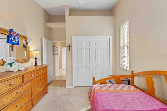 bedroom with light colored carpet and a closet