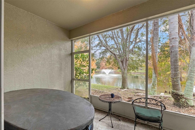 unfurnished sunroom with a water view