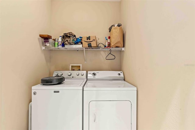 laundry area featuring washing machine and clothes dryer