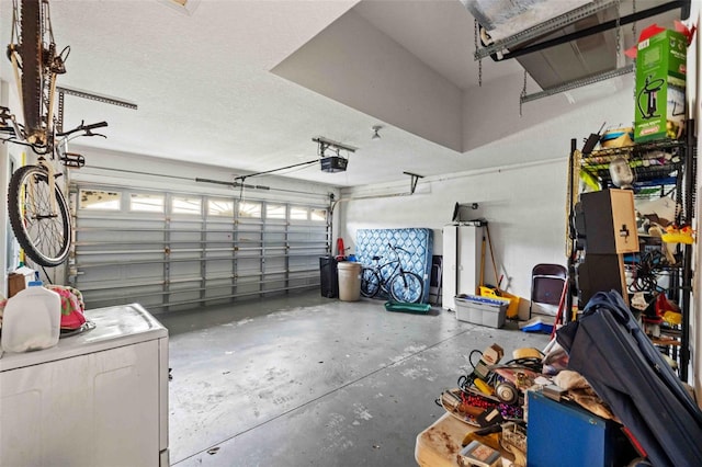 garage with washer / dryer and a garage door opener