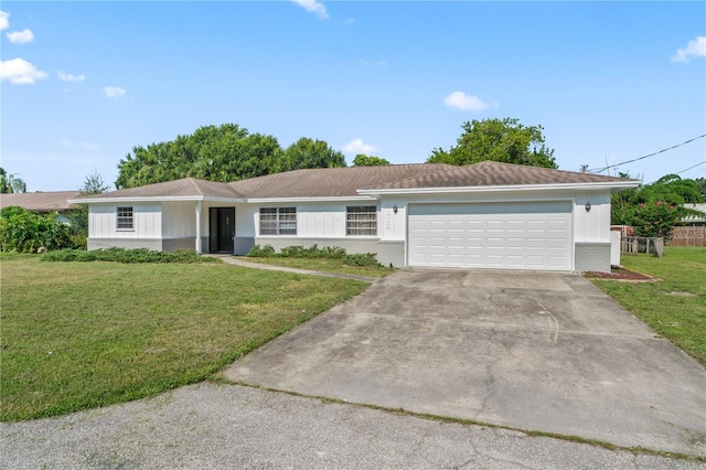 single story home featuring a garage and a front lawn