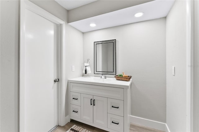 bathroom with hardwood / wood-style floors and vanity