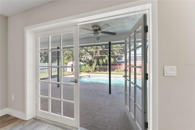 doorway featuring ceiling fan and hardwood / wood-style floors