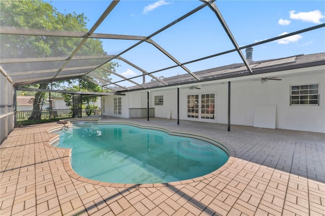 view of pool featuring ceiling fan, a patio, glass enclosure, and french doors