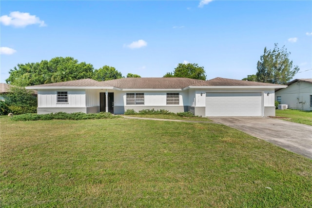 ranch-style home featuring a garage, a front lawn, and central air condition unit