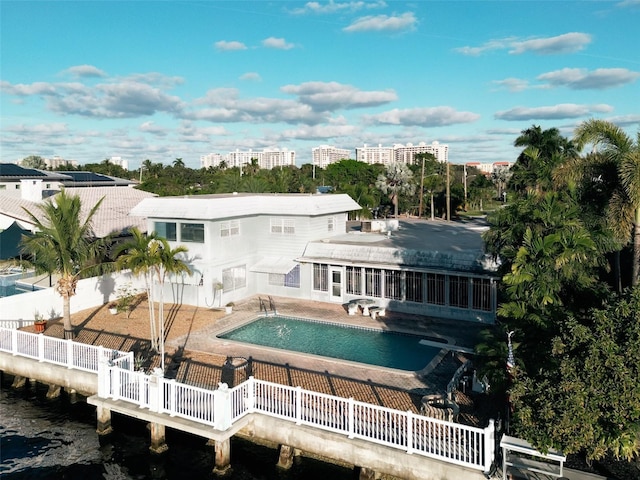 rear view of house featuring a water view and a patio