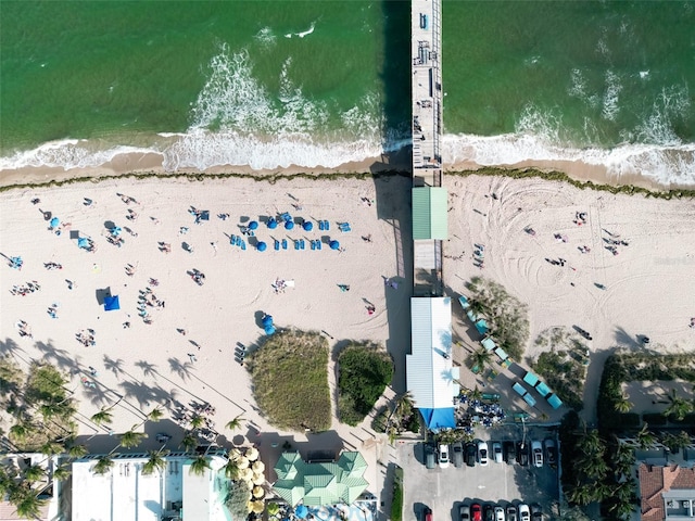 aerial view with a water view and a beach view