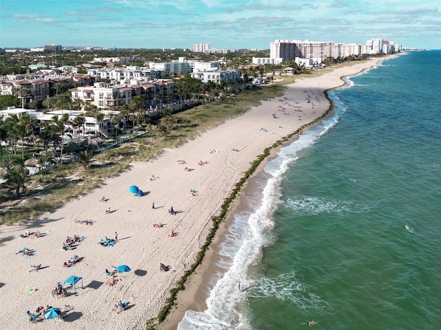 birds eye view of property featuring a view of the beach and a water view