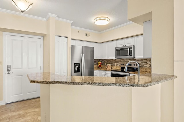 kitchen with kitchen peninsula, white cabinetry, ornamental molding, and appliances with stainless steel finishes