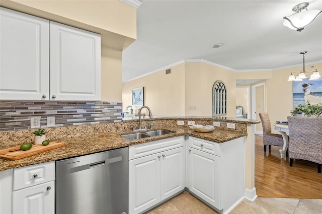 kitchen with kitchen peninsula, white cabinets, dark stone counters, sink, and dishwasher