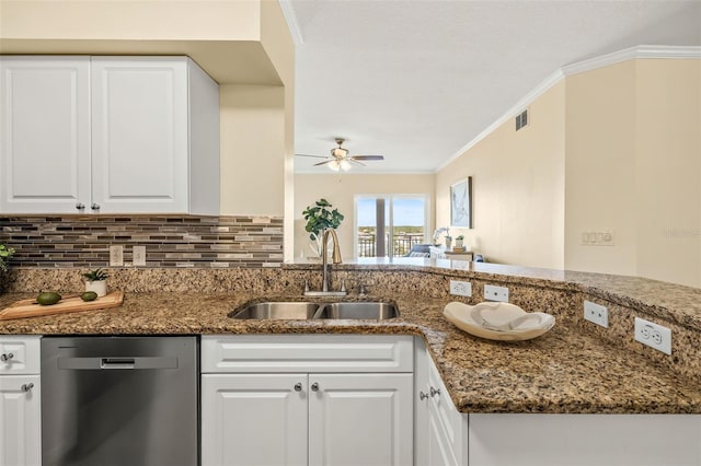 kitchen featuring stainless steel dishwasher, ceiling fan, sink, dark stone countertops, and white cabinetry