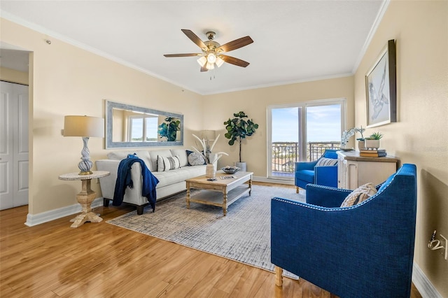 living room featuring hardwood / wood-style floors, ceiling fan, and ornamental molding