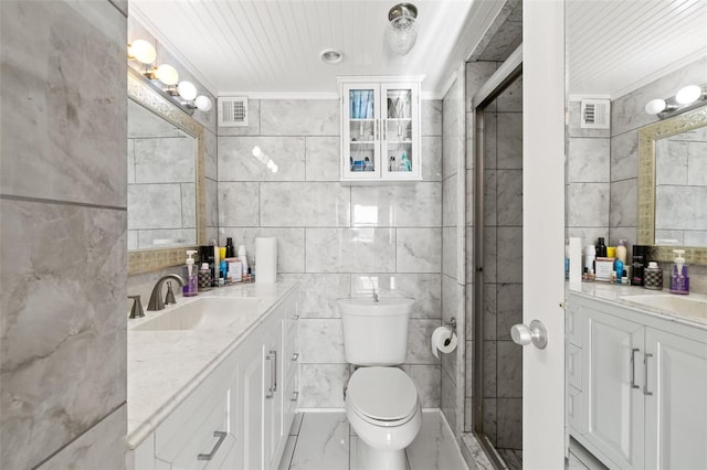 bathroom with vanity, tile walls, and crown molding