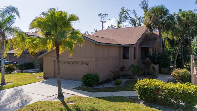 view of front of property featuring a front yard and a garage