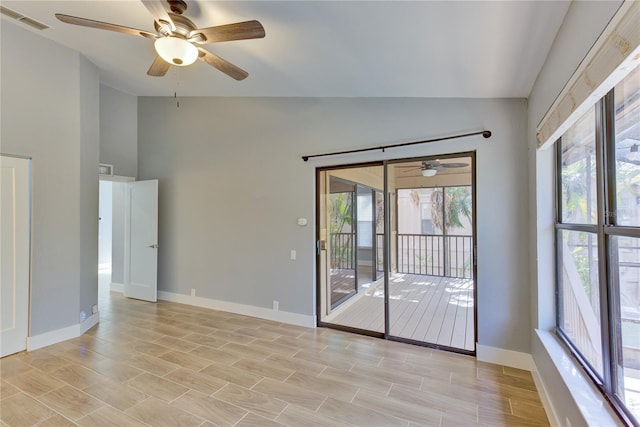 unfurnished room with plenty of natural light, ceiling fan, light hardwood / wood-style flooring, and vaulted ceiling