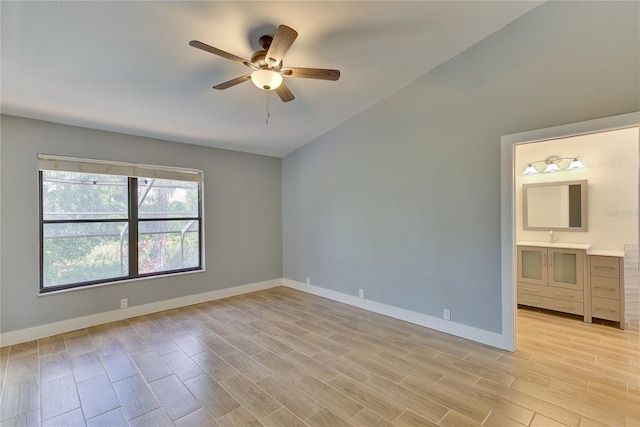 unfurnished room featuring ceiling fan, light hardwood / wood-style flooring, vaulted ceiling, and sink