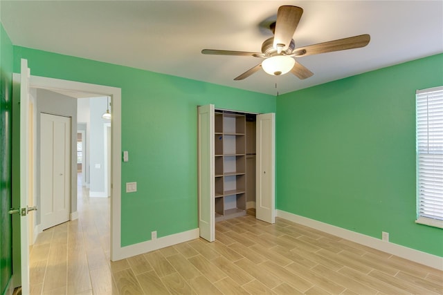 unfurnished bedroom with ceiling fan, light hardwood / wood-style floors, and a closet