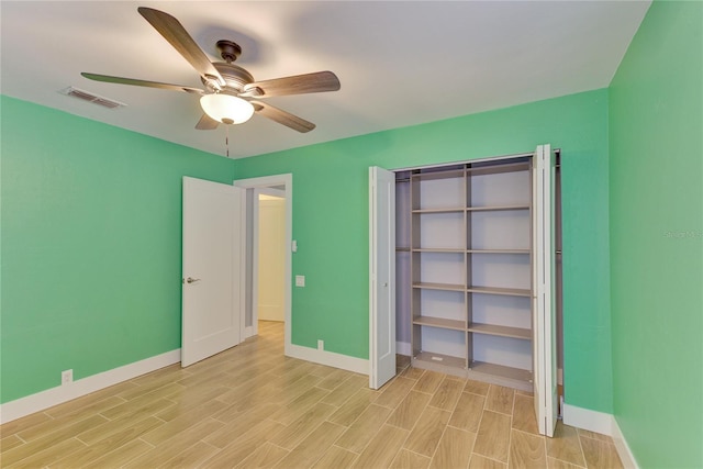 unfurnished bedroom with a closet, light hardwood / wood-style flooring, and ceiling fan