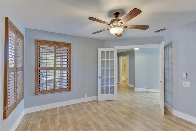 spare room featuring ceiling fan, french doors, and light hardwood / wood-style flooring