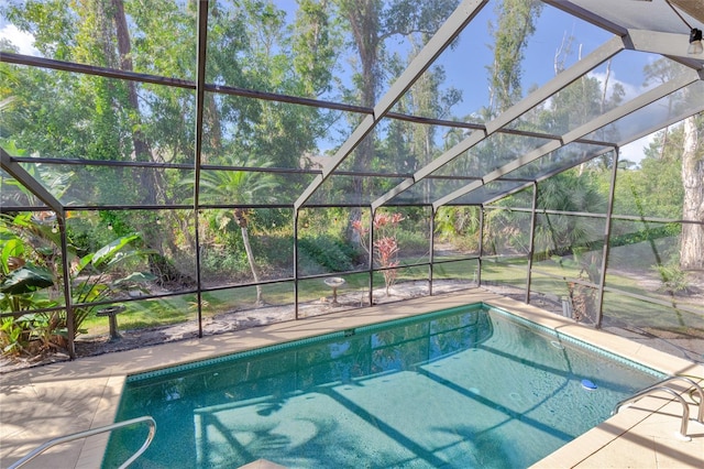 view of swimming pool with glass enclosure