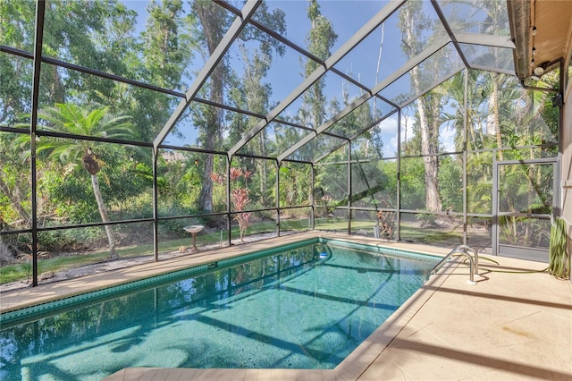 view of swimming pool with a patio and a lanai