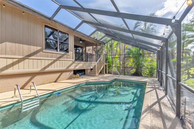 view of swimming pool with a patio area and a lanai