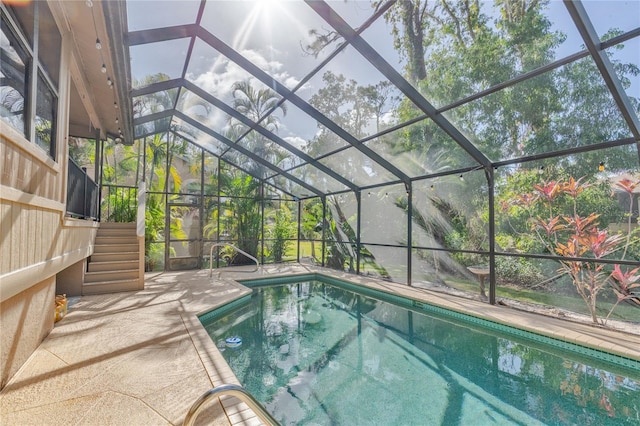 view of swimming pool with a lanai and a patio